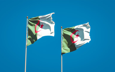 Beautiful national state flags of Algeria and Algeria together at the sky background. 3D artwork concept.