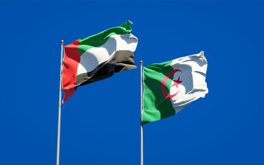 Beautiful national state flags of United Arab Emirates UAE and Algeria together at the sky background. 3D artwork concept.