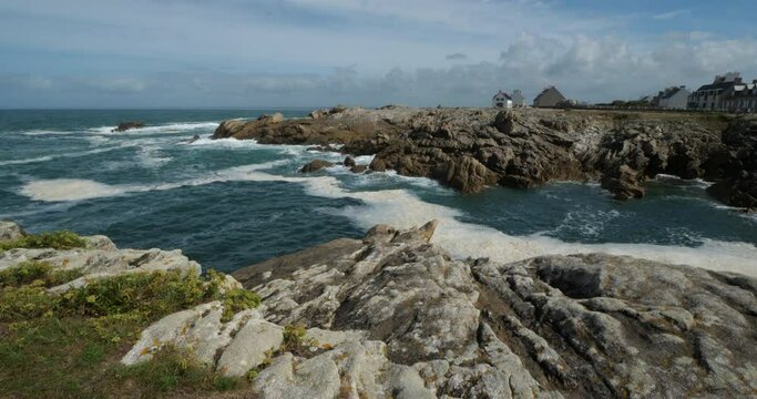 Penmarch, Finistere department, Brittany, France. Pointe of Penmarch with the famous rocks. Pointe of Penmarch with the famous rocks..On the foreground are wild flowers named rock samphire.