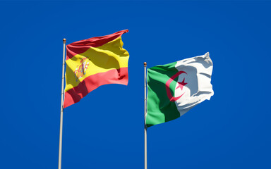 Beautiful national state flags of Spain and Algeria together at the sky background. 3D artwork concept.