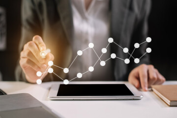 Businessman using tablet and stock market charts at office in the morning. 