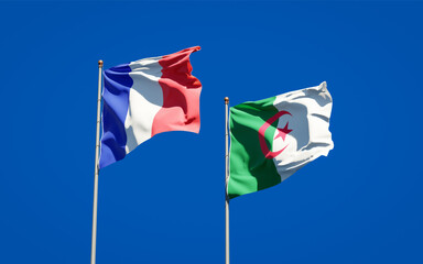 Beautiful national state flags of France and Algeria together at the sky background. 3D artwork concept.