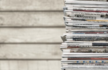 Pile of fresh newspapers on a blur background