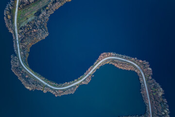 Aerial top down view on a winding s-shaped road between two lakes in the Republic of Karelia