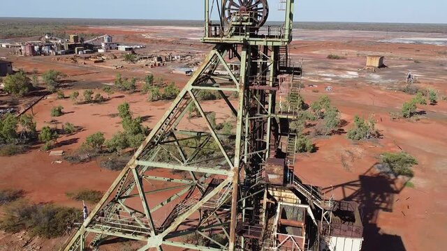 Aerial Shot of the Headframe in an Abandoned Australian Mining Town. Factory in the Background. Location: Warrego Town, Northern Territory.