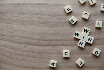 Top view of alphabet of words Win Win on wooden background. 