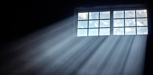 the sun's rays make their way through the lattice window. Organic drop diagonal shadow and rays of light from window.
