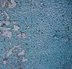 Blue peeling paint on concrete wall texture. An old grunge city pattern