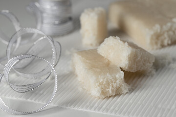 Artisan Coconut Nougat or Turron de coco  on white background with Christmas decoration.