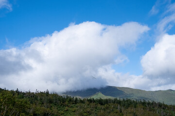 View of cloudy mountain ranges by Lake Rausu