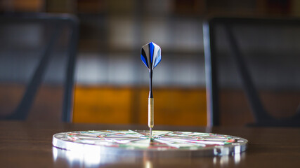 Close up shot of the dart arrow hit on bulleyes of dartboard to represent that the business reached the target.