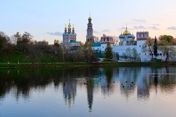 Fototapeta na wymiar Novodevichy Convent and the pond nearby - pre-sunset reflections