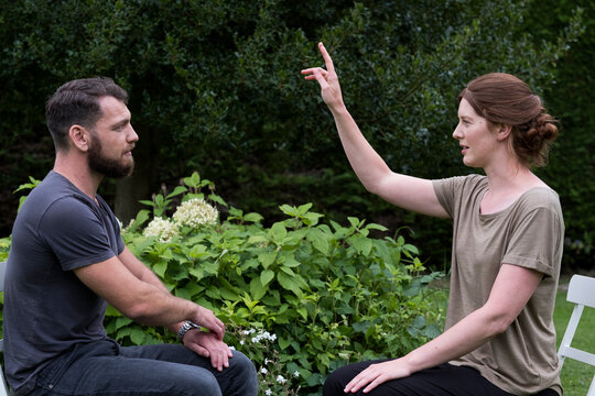 Man and female therapist in a garden, sharing techniques of EFT