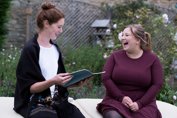 A woman and a therapist talking in a garden. 