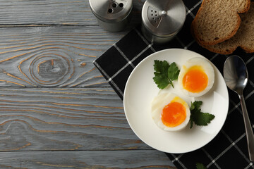 Concept of breakfast with boiled eggs on wooden background