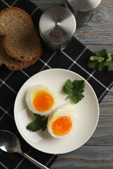 Concept of breakfast with boiled eggs on wooden background