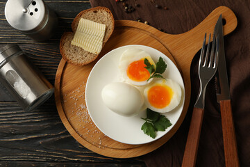 Concept of breakfast with boiled eggs on wooden background