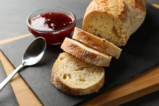 Concept of breakfast with toast with jam on wooden background