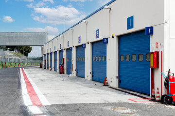 Motor sport circuit asphalt track pit lane with closed box aligned