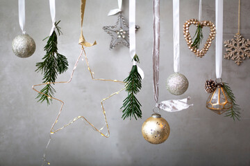 Christmas decorations, close up of silver, white and golden Christmas baubles on ribbons