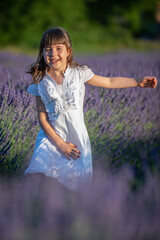 Beautiful little girl in a lavender field in Italy