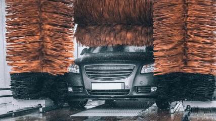 Carwash auto clean service with soap water. vehicle hand wash car from foam on cleaner station.