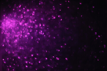 Purple sparkling defocused light on black background, Purple bokeh, abstract background stock photo, Christmas Decoration