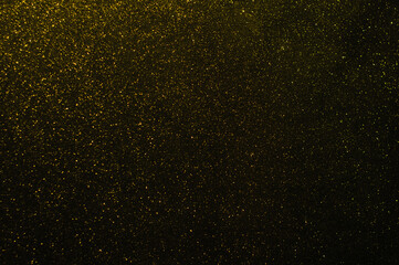 Fototapeta na wymiar Magic sparkles stock photo, Defocused Gold Lights Over Dark Background, Abstract Backgrounds
