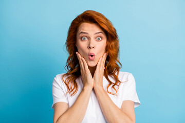 Photo portrait of shocked girl touching face cheeks with two hands isolated on pastel blue colored...