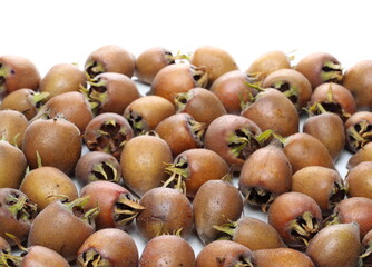 Fresh medlar fruits pile isolated on white background