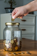 Coins half full crystal pot and a hand