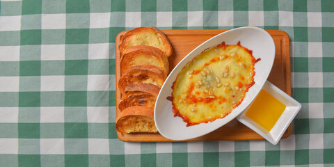 Zucchini baked with cheese in a dish, close up food. Delicious meat and cheese casserole. Italian cuisine concept.