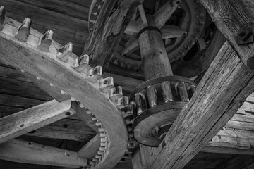 Pinion gear in old wooden mechanism of windmill