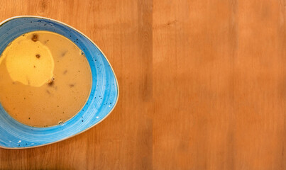 Banner with delicious and appetizing soup with vegetables, tomato and meat, homemade bread, served at wooden table with spoon at smooth old wood background for copy space text, details, closeup.