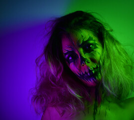 Woman with makeup and photographed in the dark with colored led lights.