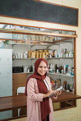 portrait of young Muslim women selling packaged products