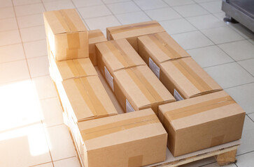 Pallet with cardboard boxes in production. The concept of cheap and durable cardboard packaging at a low cost