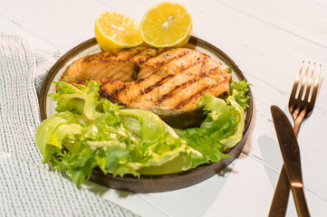 Homemade organic salmon steak with lettuce leaves