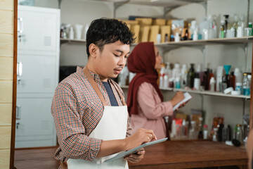 portrait young man and muslim woman notes product sales