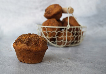  The  pumpkin muffin with cinnamon and basket of muffins in the background                     