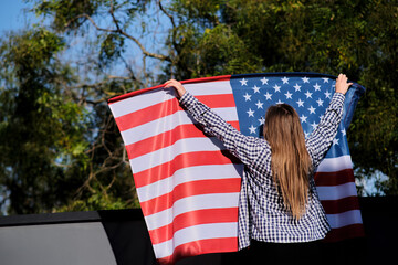 Girl with american flag, presidential election. The patriot who voted.