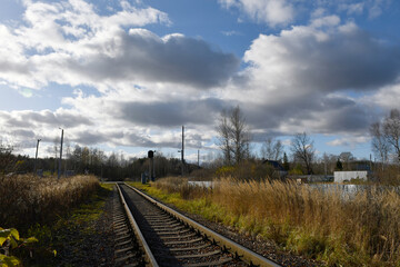 Fototapeta na wymiar A narrow-gauge railway extending into the distance. Railway crossing in the distance