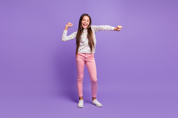 Full length body size photo schoolgirl smiling happily dancing wearing casual clothes laughing isolated on bright violet color background