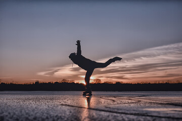 one guy skates on the ice of a frozen lake, nature landscape, man outdoor sports
