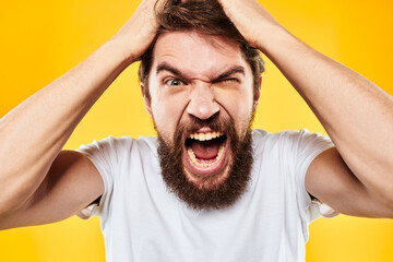 bearded man gesturing with hands studio lifestyle discontent yellow background
