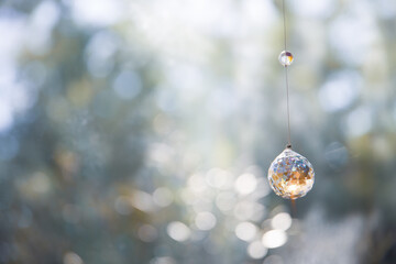 美しいガラスのクリスタルのサンキャッチャーの飾りがある窓辺