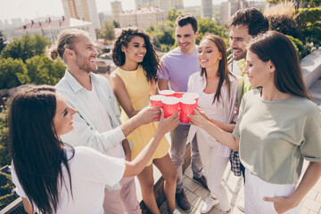 Photo of company of good friends arms hold alcohol cups clink say toast gathering roof top restaurant outdoors
