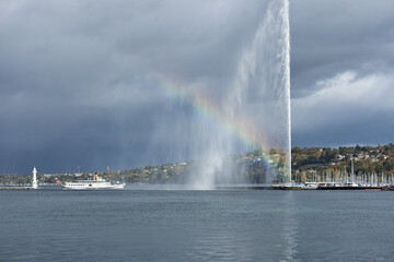 Naklejka na ściany i meble vintage steamboat arriving in the harbor with the water jet and a rainbow in Geneva, Switzerland