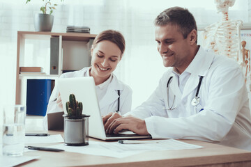 Male doctor sitting at the table and working. 