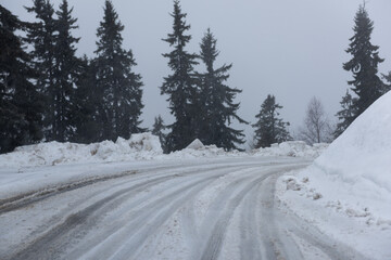 Snow covered dangerous mountain road in bad weather condition.